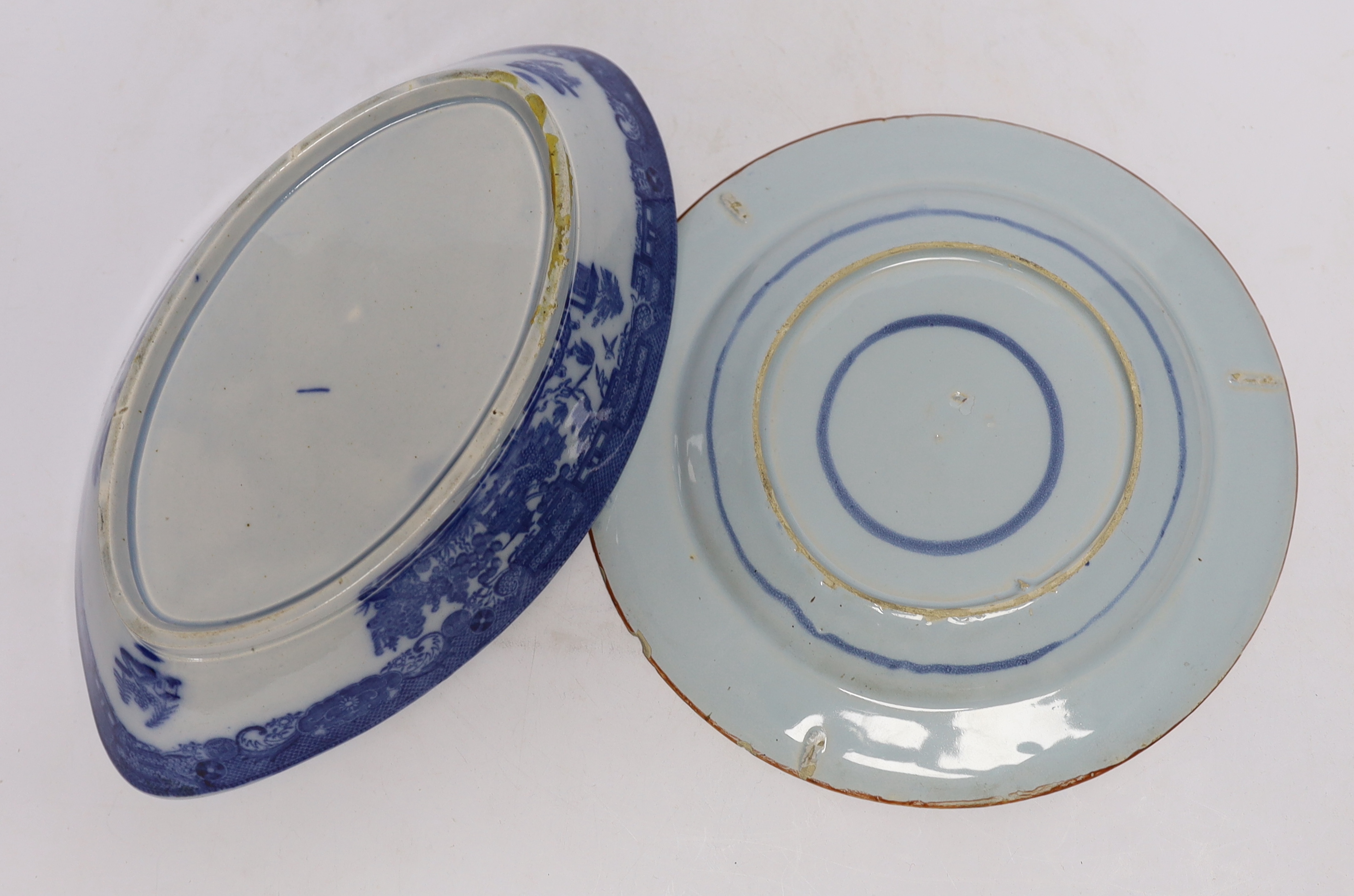 An 18th century delftware plate and blue and white pearlware plate, largest 28cm wide